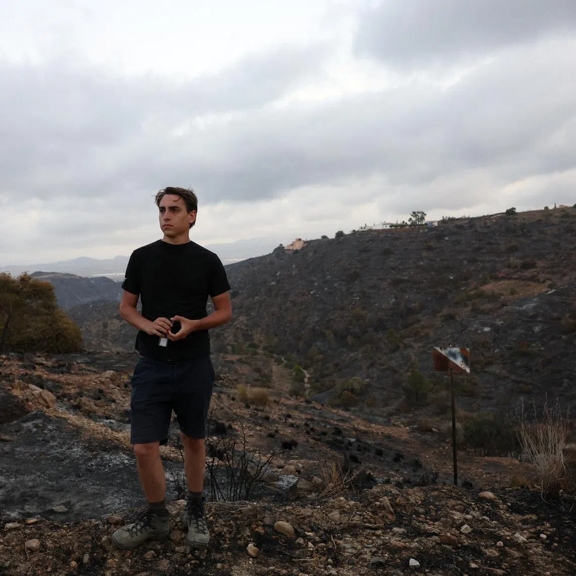 Thomas-Wolf Verdonckt observes the landscape where his father 63-year-old Stanislas Verdonckt was killed in deadly wildfires affecting Almeria province, in Bedar, Spain, July 11, 2026. REUTERS