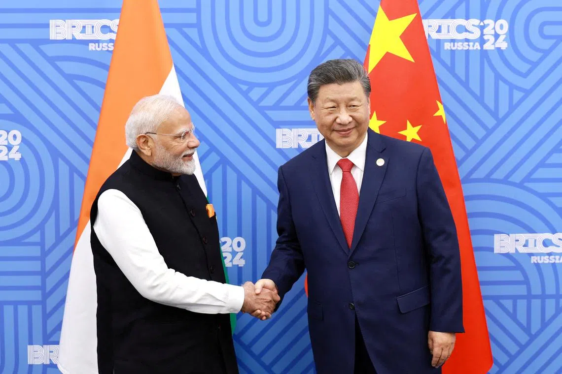 FILE PHOTO: Chinese President Xi Jinping and India Prime Minister Narendra Modi meet on the sidelines of the BRICS summit in Kazan, Russia October 23, 2024. China Daily via REUTERS/File Photo