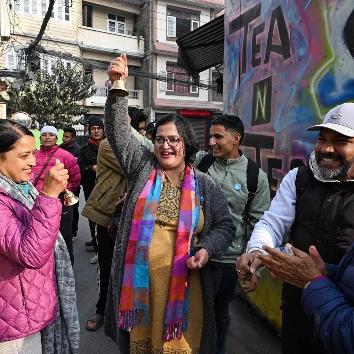 Rastriya Swatantra Party (RSP) election candidate Ranju Darshana (C) meets residents during a door-to-door campaign with her party workers on Feb 13, ahead of Nepal's general election.