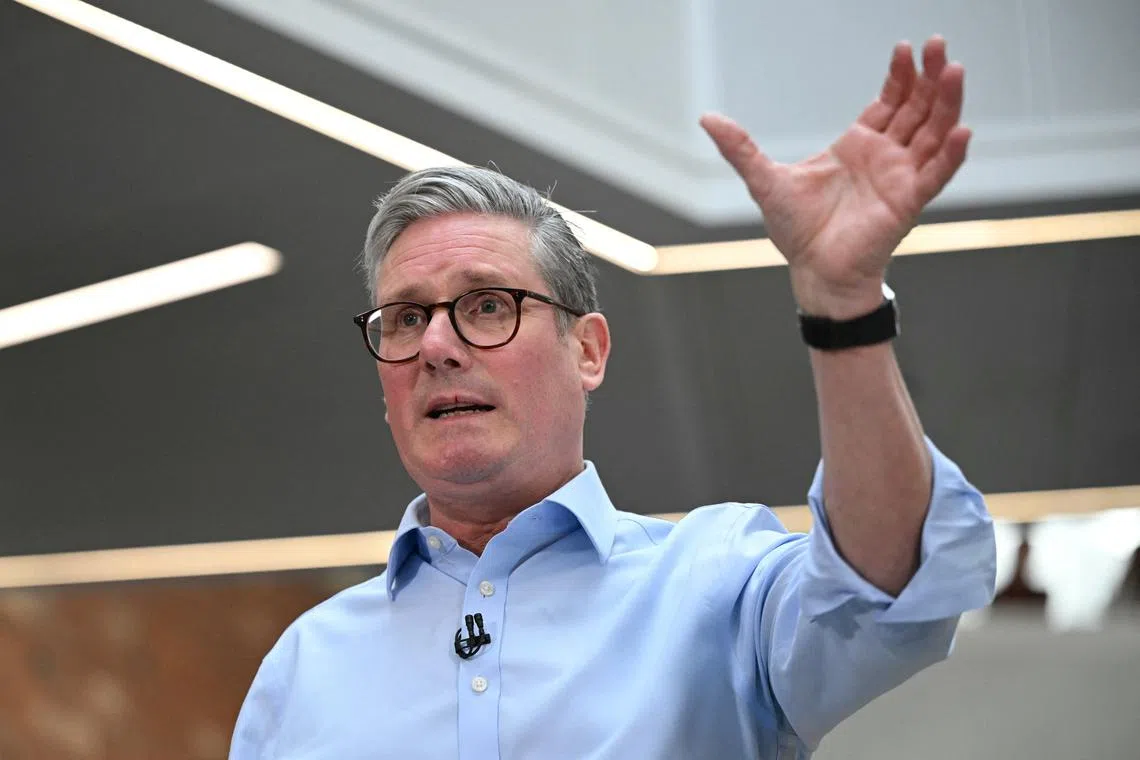FILE PHOTO: Britain's Prime Minister Keir Starmer gestures during a Q&A session after delivering a speech on plans to reform the civil service, during a visit to Reckitt Benckiser Health Care UK Ltd in Kingston upon Hull, Britain, March 13, 2025.  OLI SCARFF/Pool via REUTERS/File Photo