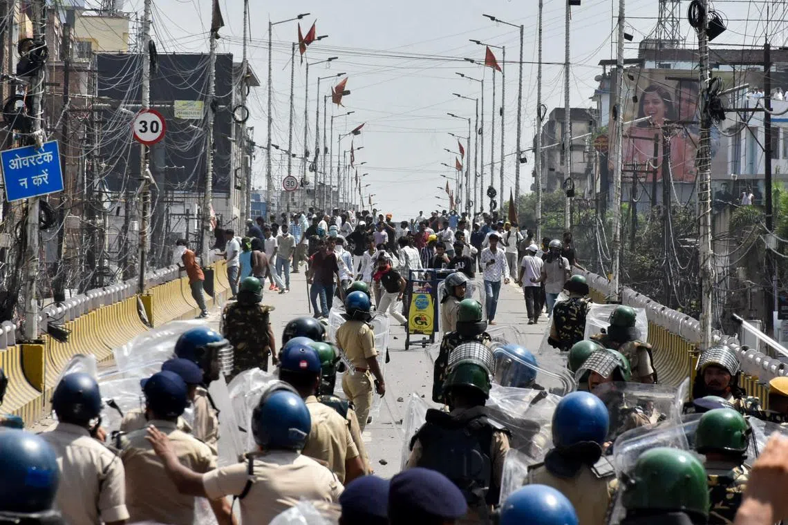 Protesters engage in a clash with policemen during Bihar Bandh call for demanding the resignation of Education Minister Dharmendra Pradhan over National Eligibility cum Entrance Test examination paper leaks, in Patna, India, on July 25.