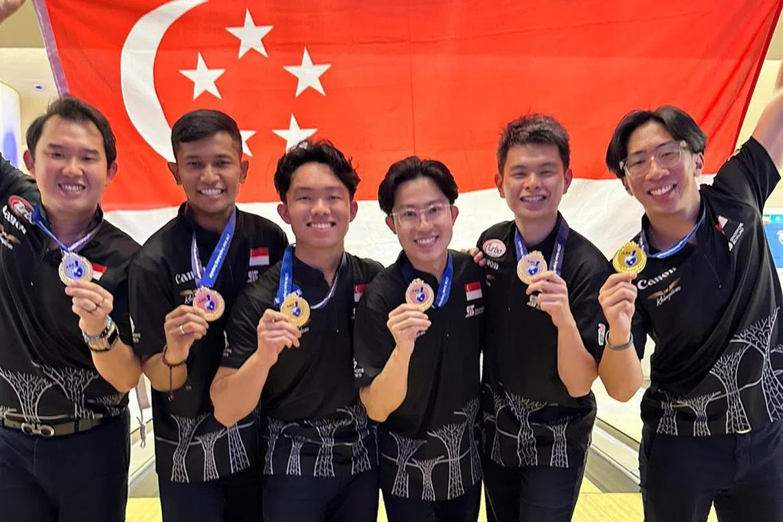 (From left) Singapore's Jaris Goh, Nu’man Syahmi, Mike Ong, Darren Ong and Joel Tan celebrating the country's first men's team gold at the Asian Tenpin Bowling Championships since 1982.