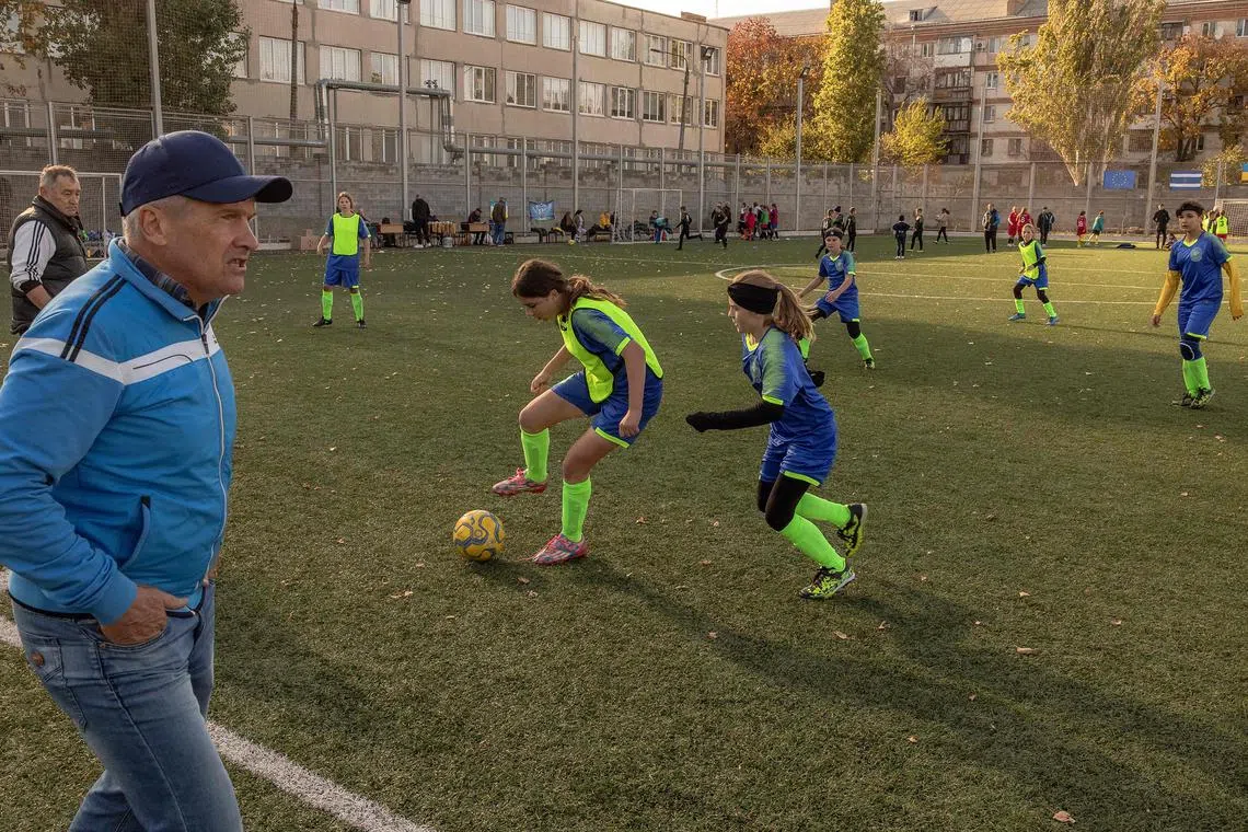 Krystal Kherson deputy coach Igor Psurtyev and players during a football tournament in Mykolaiv, Ukraine, on Nov 10.