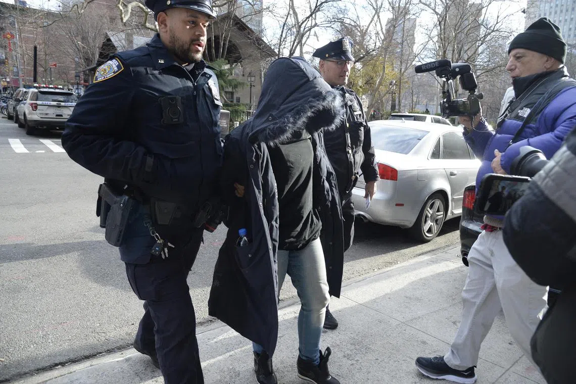 Police escort Shanice Aviles, who was arrested for allegedly breaking into Robert De Niro's townhouse in New York.