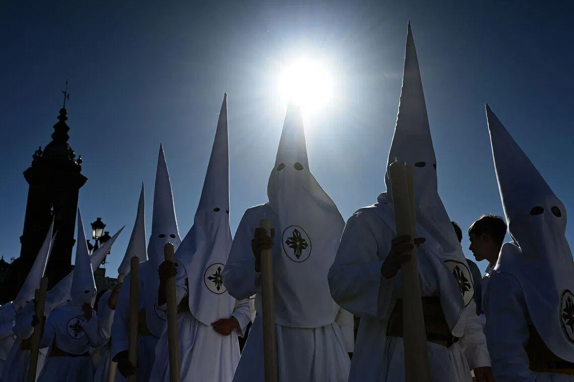 Penitents of the San Gonzalo brotherhood taking part in the Holy Monday procession in Seville, Spain, on March 30, 2026. Christian believers around the world mark Holy Week in celebration of the crucifixion and resurrection of Jesus Christ. 