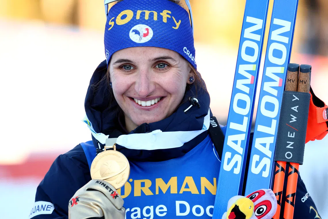 FILE PHOTO: Winter Sports - Biathlon World Championships - Lenzerheide, Switzerland - February 18, 2025 Gold medallist France's Julia Simon celebrates on the podium after winning the Women's 15km Individual REUTERS/Denis Balibouse/File Photo