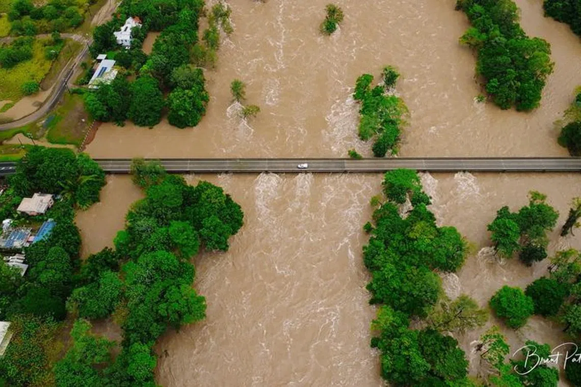 An aerial view shows flooding caused by heavy rains and water gushing through the Barron River, in Cairns, Queensland, Australia December 18, 2023 in this screen grab obtained from social media video. Brent Paterson/via REUTERS