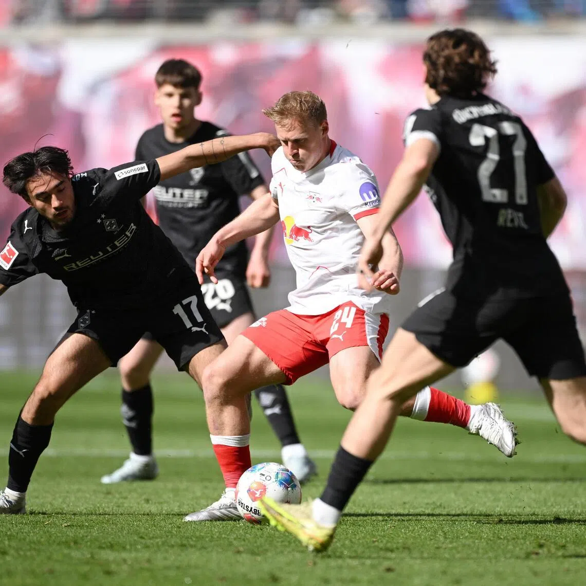 Borussia Moenchengladbach's Jens Castrop closing down RB Leipzig's Xaver Schlager in their Bundesliga game at Red Bull Arena in Leipzig, Germany on April 11, 2026.