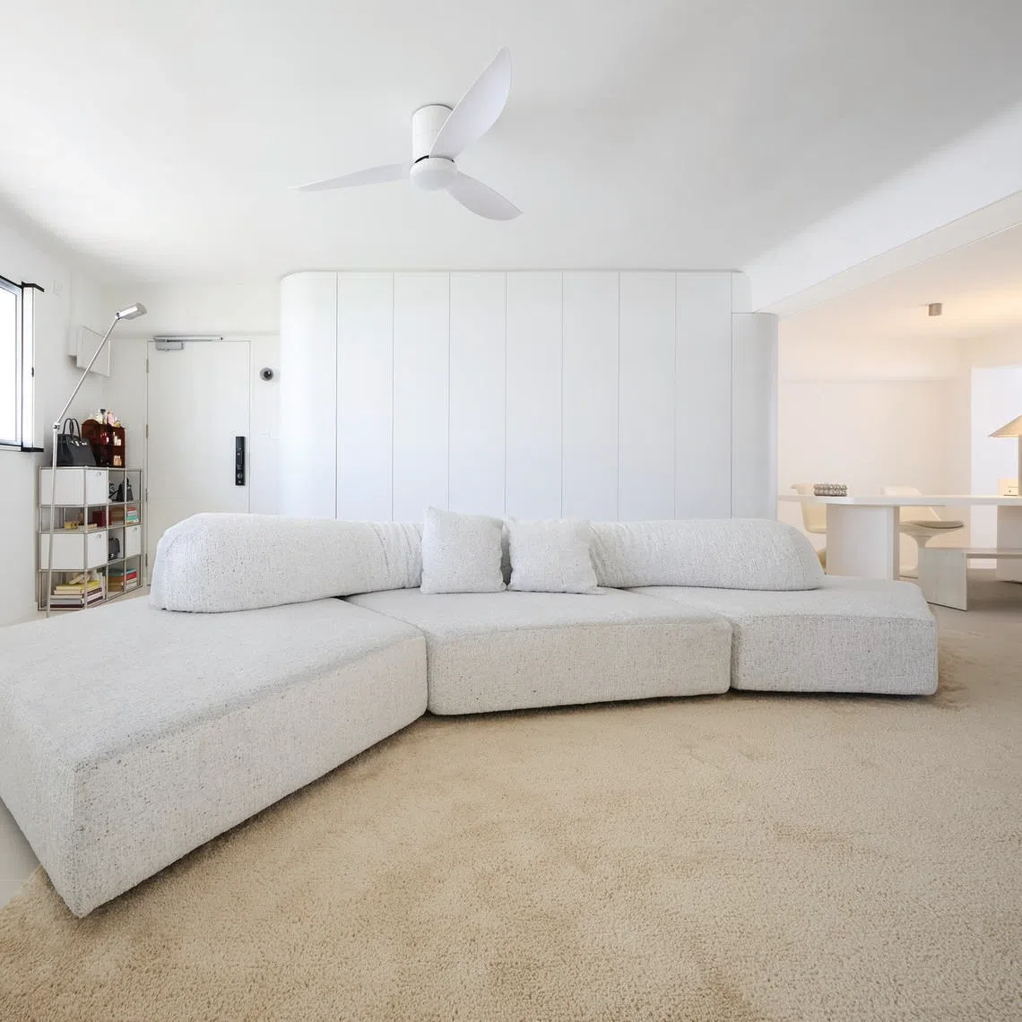 White and cream tones bounce off one another in the living area of Ms Neo Lirong's HDB flat.