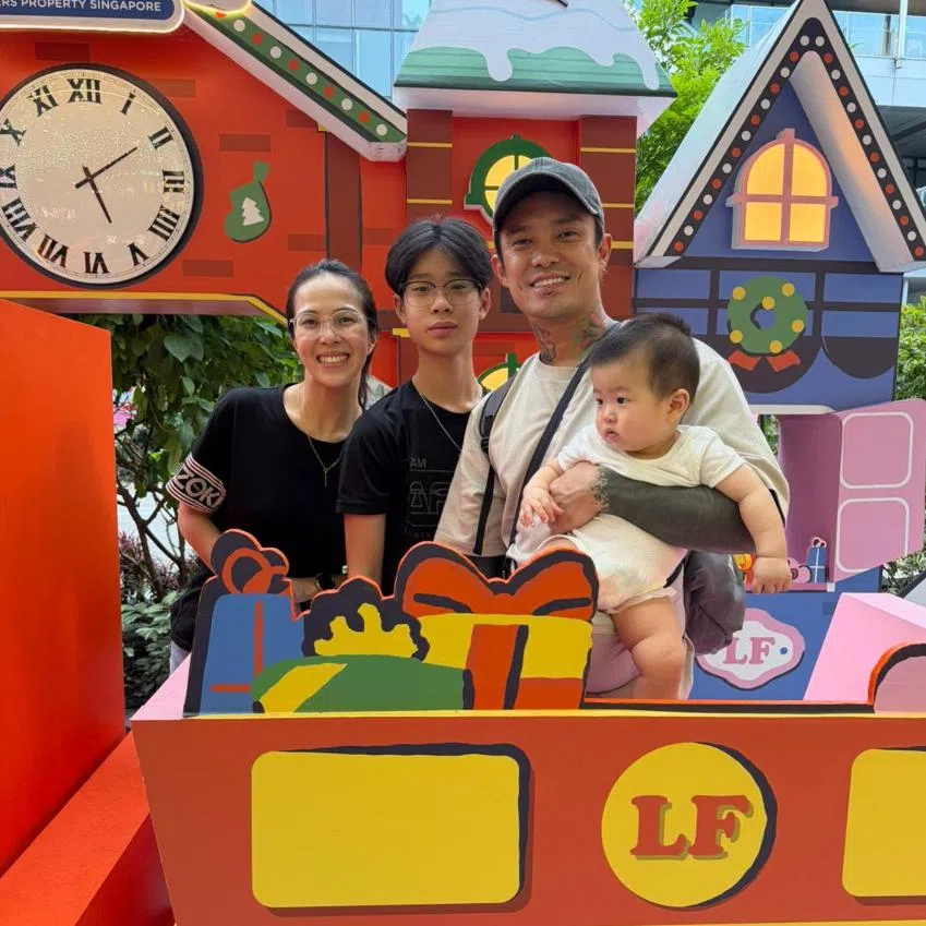 Content creator Simon Khung (second from right), better known as Simonboy, posing with the Christmas displays in Orchard Road with (from left) his wife Chloe Eong; his elder son, Caius, 14; and younger son, 10-month-old Sunny.