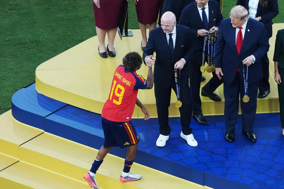 Soccer Football - FIFA World Cup 2026 - Final - Spain v Argentina - New York/New Jersey Stadium, East Rutherford, New Jersey, U.S. - July 19, 2026 Spain's Lamine Yamal receives the winner's medal from FIFA President Gianni Infantino and U.S. President Donald Trump during the trophy presentation IMAGN IMAGES via Reuters/James Lang