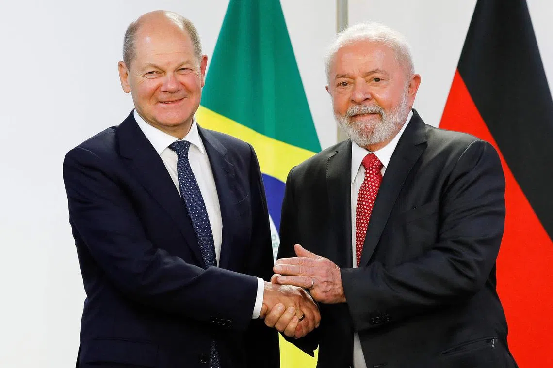 German Chancellor Olaf Scholz (left) is welcomed by Brazilian President Luiz Inacio Lula da Silva.