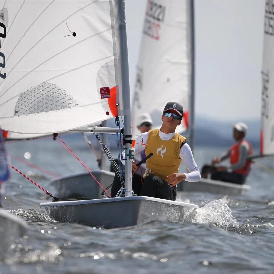 Ian Goh (centre) of Singapore in action during the Asian Games Boys? Dinghy Final at the Kaiyoh Yacht Harbour on Oct 3, 2026.