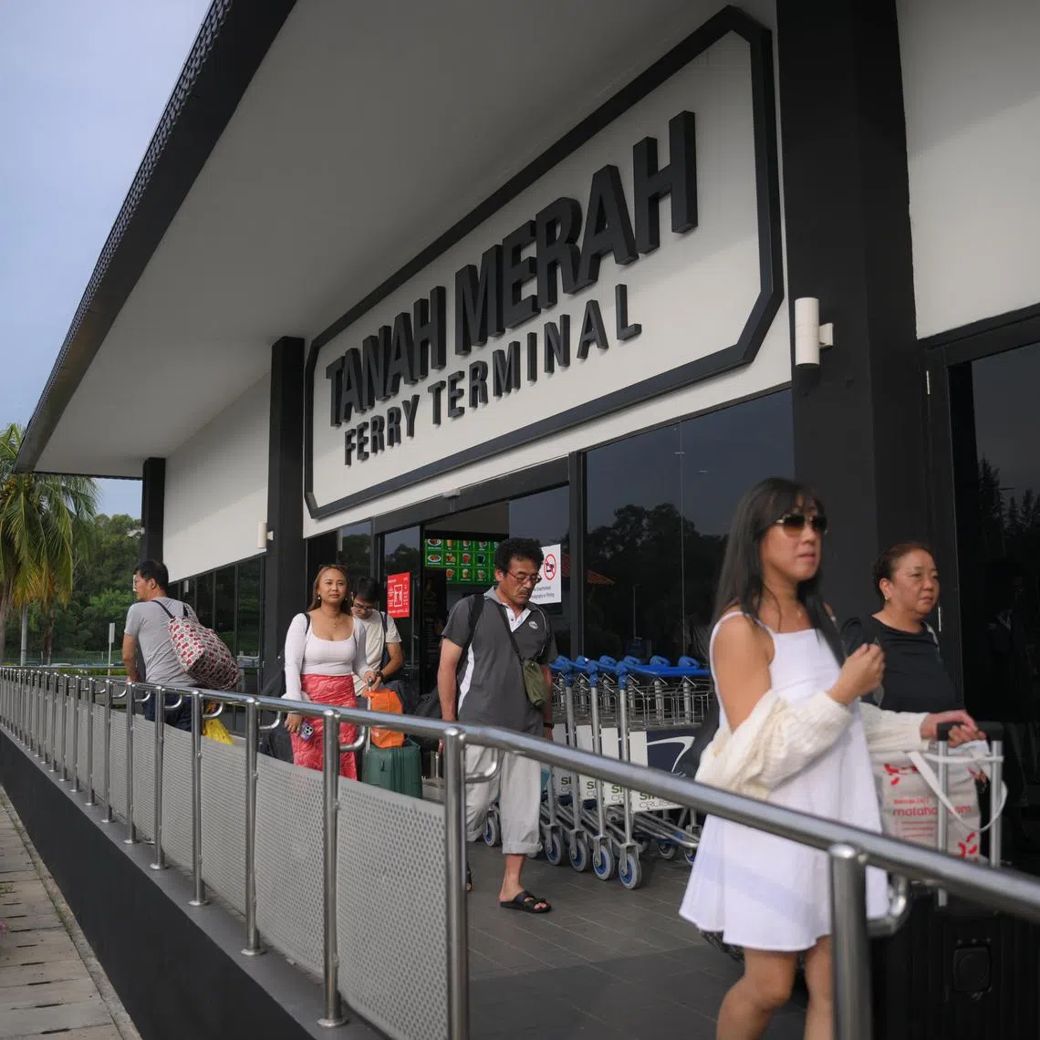 Passengers exit Tanah Merah Ferry Terminal on June 21, 2025.