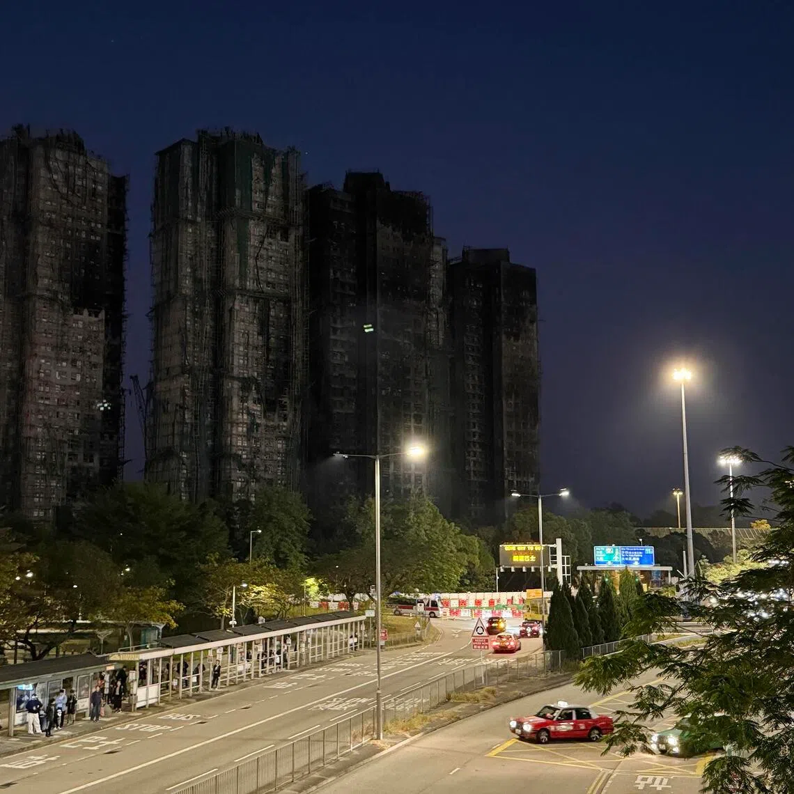 mfletter22 - As the sun sets and the lights come on in Hong Kong on Dec 17, 2025, the dark outlines of the charred towers of Wang Fuk Court look particularly stark, brutal even, against the Tai Po skyline, as if determined to remind every passer-by of the city’s recent sorrow.
ST PHOTO: MAGDALENE FUNG