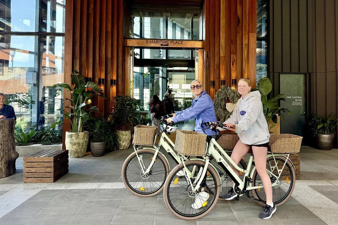 The writer and her daughter on e-bikes at 1 Hotel Melbourne.