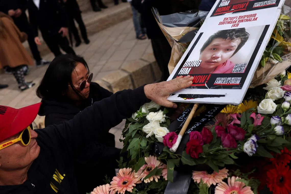 People attend a ceremony for the repatriation of the remains of Thai hostage Sudthisak Rinthalak at Ben Gurion International Airport in Israel on Dec 9, 2025.