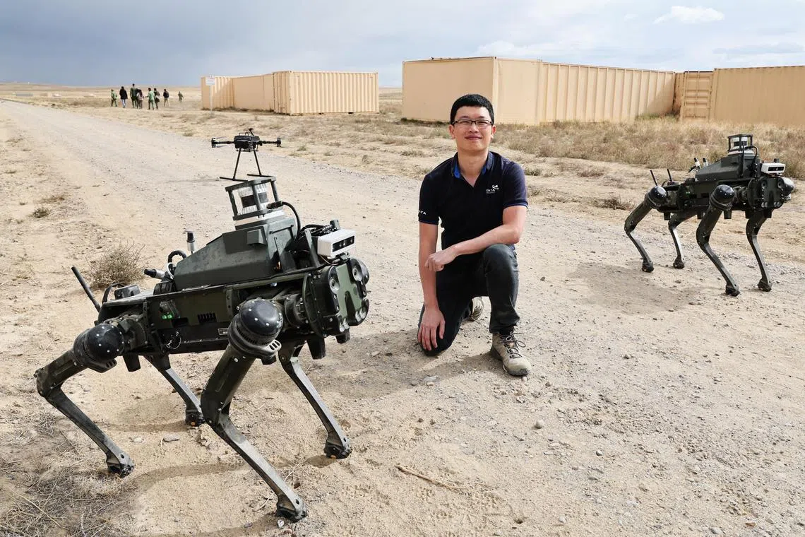 ** Embargoed 9 am, 25 Sept (Monday, SG Time) **

Mr Bryan Ng, who heads the capability development of unmanned ground vehicles at the Defence Science and Technology Agency, posing with two robot dogs in Idaho. The Singapore Army is currently trialling them as part of Exercise Forging Sabre.