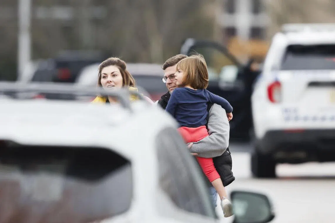 epa11781494 A child is carried away from the scene of a shooting at Abundant Life Christian School in Madison, Wisconsin, USA, 16 December 2024. According a social media post by the Madison Police Department, three people, including the shooter, were killed in the shooting and the suspected shooter was a student at the school. EPA-EFE/JEFFERY PHELPS