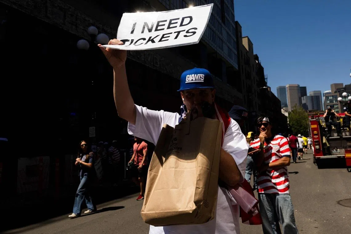 A fan asks for tickets before the round-of-16 match between USA and Belgium on July 6.