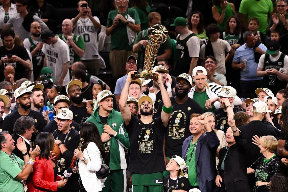 Boston Celtics forward Jayson Tatum holds up the Larry O'Brien trophy after winning the NBA Finals. The Celtics are owned by an investment group, whereas Red Bull is a consumer company if it goes ahead with bidding for a new NBA franchise.