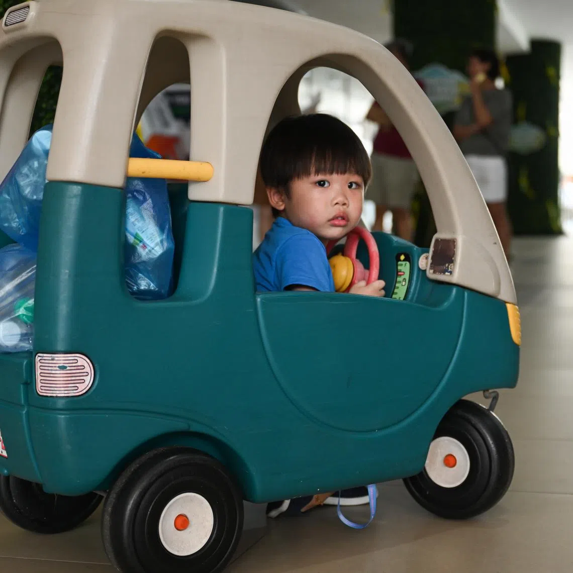 3-year-old Ethan Bei arrived in a toy car with bottles of water to recycle at Tiong Bahru Community Centre on April 11, 2026, as part of the recycling pilot called Love Tiong Bahru.