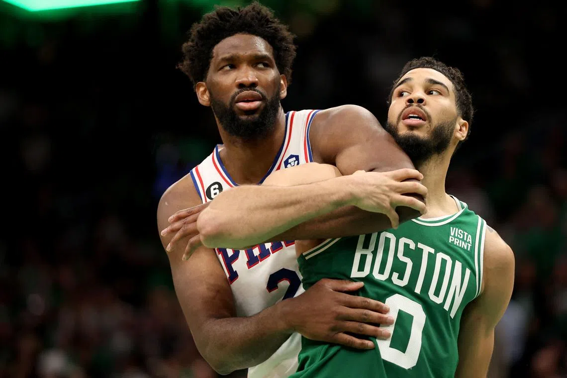Jayson Tatum of the Boston Celtics colliding with Joel Embiid of the Philadelphia 76ers during the fourth quarter in Game 7 of the NBA Eastern Conference semi-finals at TD Garden on Sunday. Tatum scored 51 points in his team's 112-88 win.