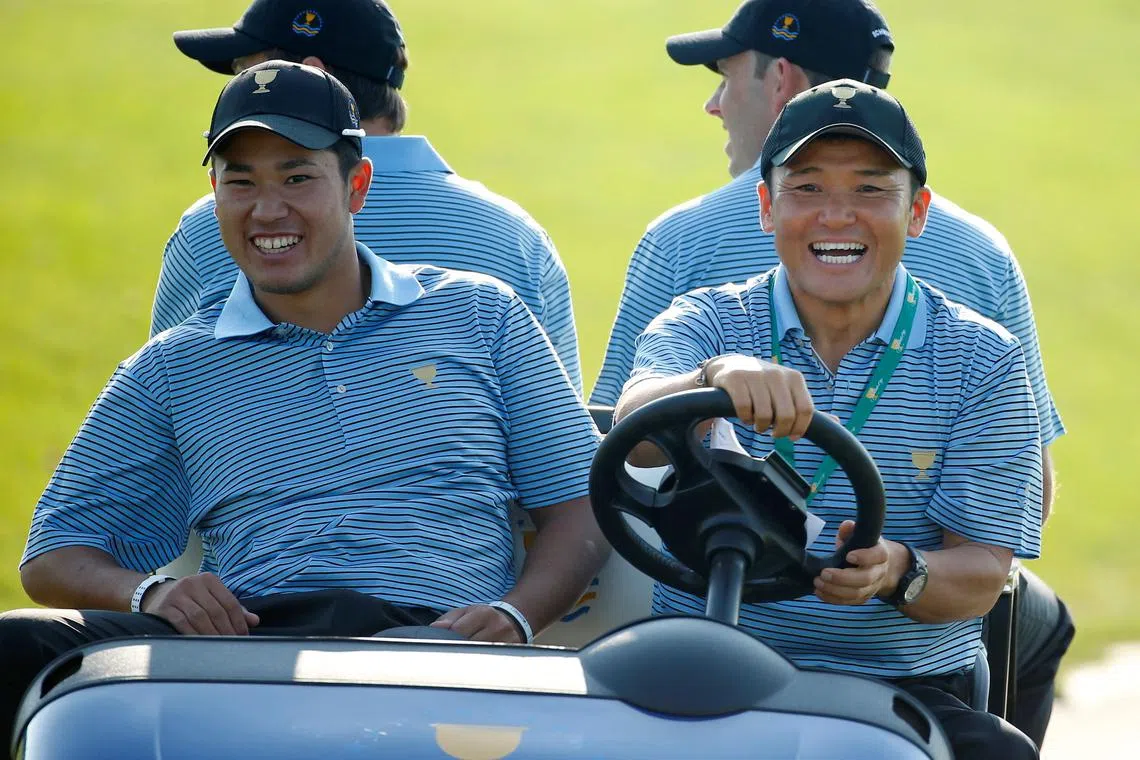 FILE PHOTO: International captain's assistant Shigeki Maruyama, of Japan, drives compatriot Hideki Matsuyama and fellow players in a golf cart during the first practice round for the 2013 Presidents Cup golf tournament at Muirfield Village Golf Club in Dublin, Ohio October 1, 2013. REUTERS/Chris Keane/File Photo