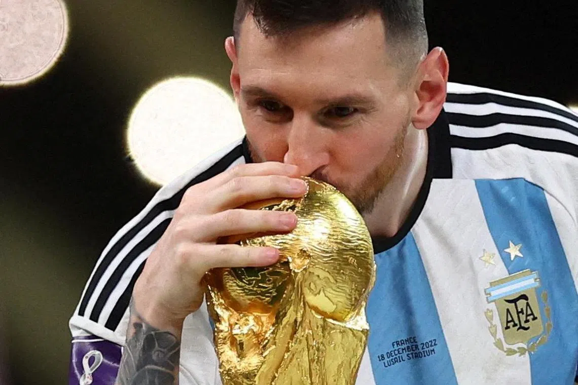 Argentina's Lionel Messi kisses the trophy as he celebrates winning the World Cup in 2022.