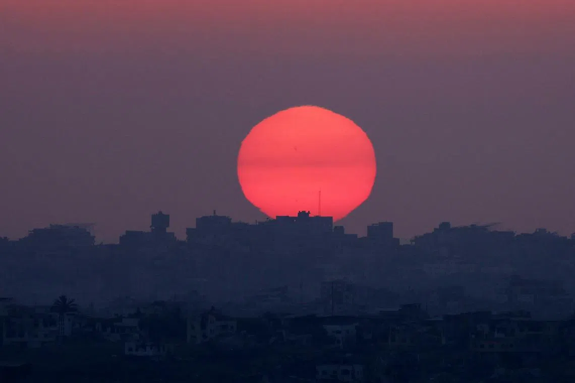 FILE PHOTO: A general view of damaged buildings in Gaza during the sunset, amid the Israel-Hamas conflict, near the Israel-Gaza border as seen from Israel, September 9, 2024. REUTERS/Florion Goga/File Photo