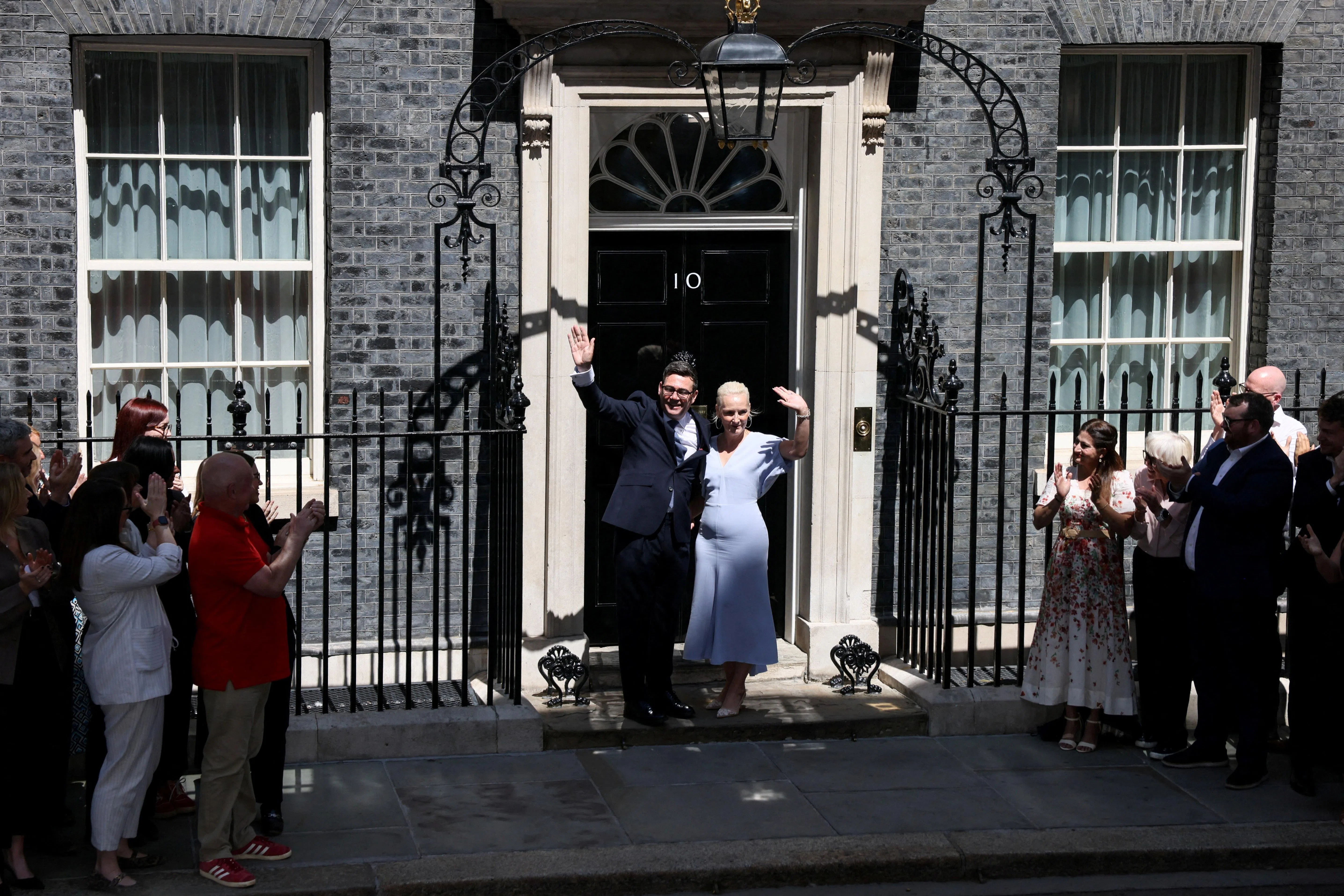 Britain's newly appointed Prime Minister Andy Burnham waves outside 10 Downing Street with his wife Marie-France van Heel after taking office, in London, Britain, July 20, 2026.    REUTERS/Jack Taylor     TPX IMAGES OF THE DAY