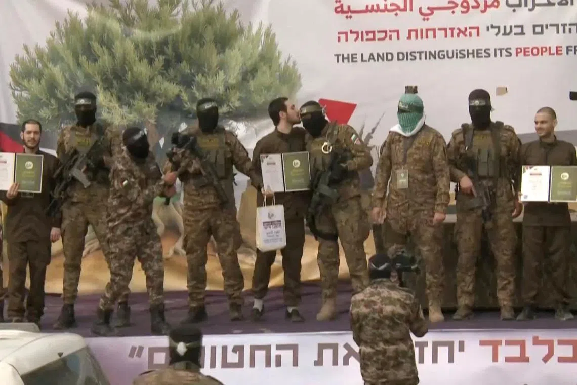 Omer Shem Tov, Eliya Cohen and Omer Wenkert, hostages held in Gaza since the deadly Oct 7, 2023 attack, are released as part of a ceasefire and a hostages-prisoners swop deal between Hamas and Israel in Nuseirat on Feb 22. 