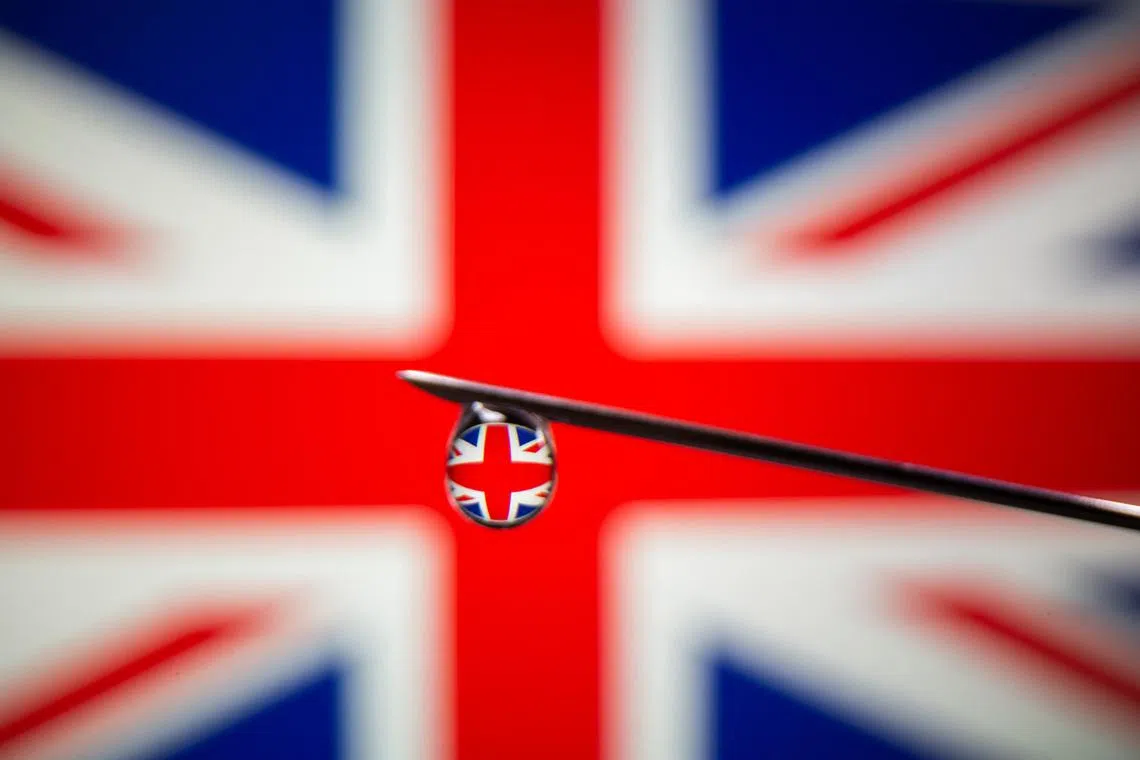 UK flag is reflected in a drop on a syringe needle in this illustration photo taken March 16, 2021. Picture taken March 16, 2021. REUTERS/Dado Ruvic/Illustration/File Photo