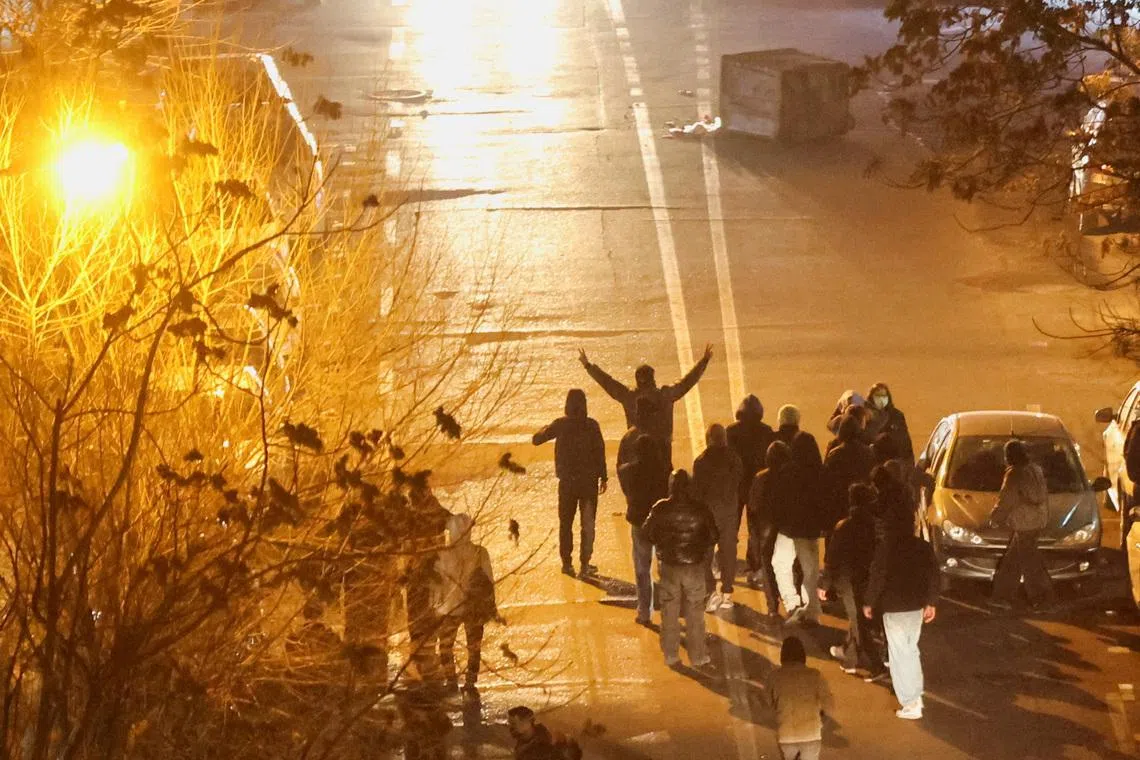 Iranian demonstrators gather in a street during a protest over the collapse of the currency's value, in Tehran, Iran, January 8, 2026. Stringer/WANA (West Asia News Agency) via REUTERS