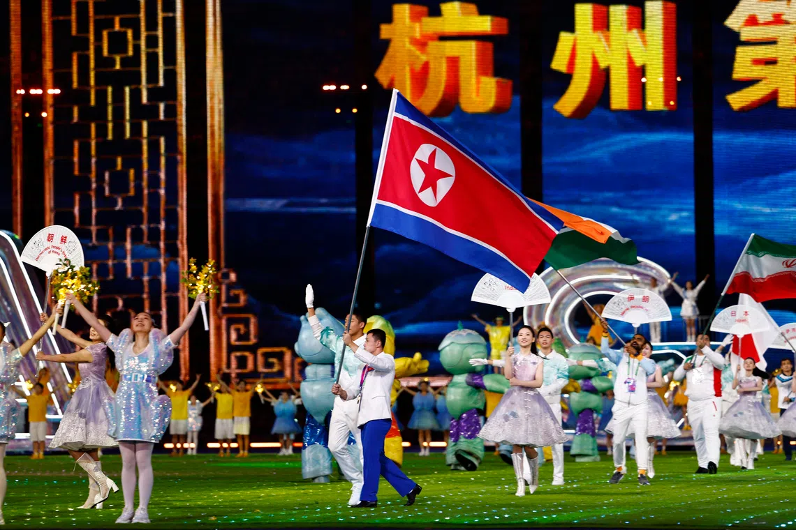 FILE PHOTO: Asian Games - Hangzhou 2022 - Closing Ceremony - Hangzhou Olympic Sports Centre Stadium, Hangzhou, China - October 8, 2023 A representative of North Korea's team walks with their national flag during the closing ceremony REUTERS/Tingshu Wang/File Photo