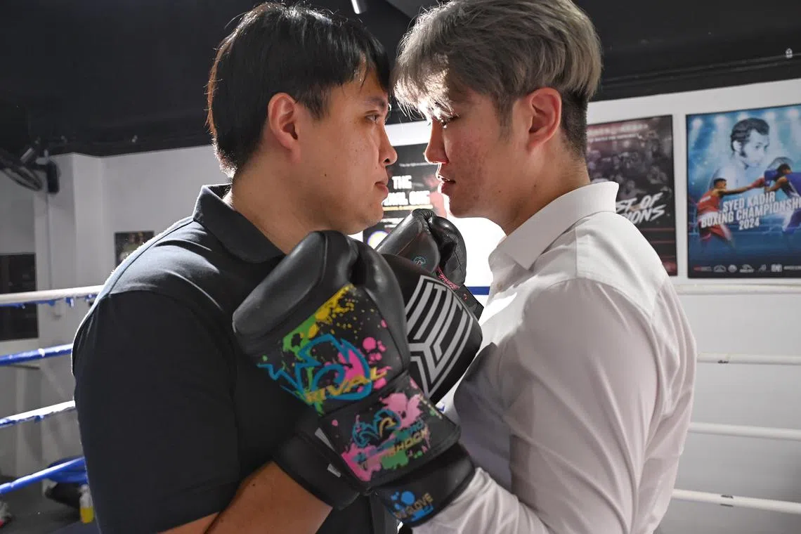 From left : Edutech business analyst Lim Xiuqi, 33, and entrepreneur Andy Tan, 35, face off ahead of their showdown at "Clash in the Lion City" set for Oct 5, promising an intense corporate boxing match.