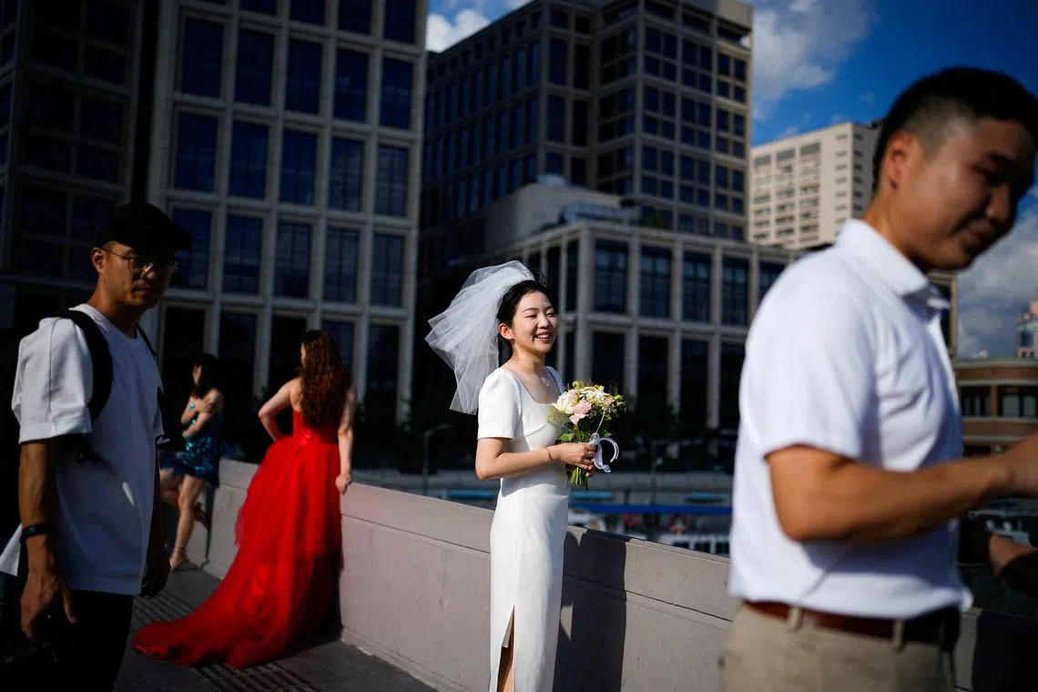 FILE PHOTO: Couples prepare to get their photo taken during a wedding photography shoot on a street, in Shanghai, China September 6, 2023. REUTERS/Aly Song/File Photo
