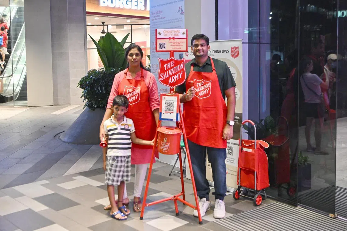 Mr Dhanasekaran Rajendiran, 35, IT Consultant, with his wife, Ms Iswarya Venugopal, 32, preschool teacher and their son, Sarvesh Dhanasekaran, 4, kettling for The Salvation Army at Century Square on Dec 2, 2023.



/Parenting feature on families volunteering together: Dhanasekaran Rajendiran, his wife and their 5-year-old are kettling for The Salvation Army for Christmas