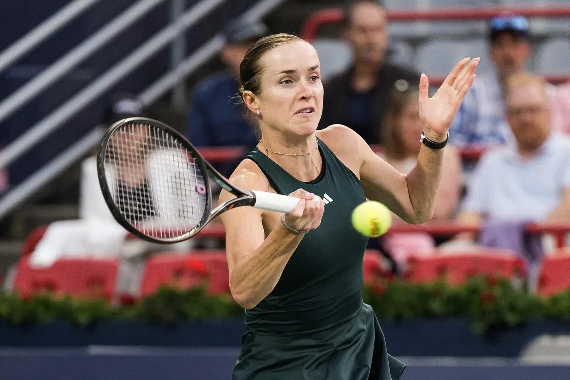 Aug 5, 2025; Montreal, QC, Canada; Elina Svitolina (UKR) returns the ball to Naomi Osaka (JPN) in quarterfinal play at IGA Stadium. Mandatory Credit: David Kirouac-Imagn Images