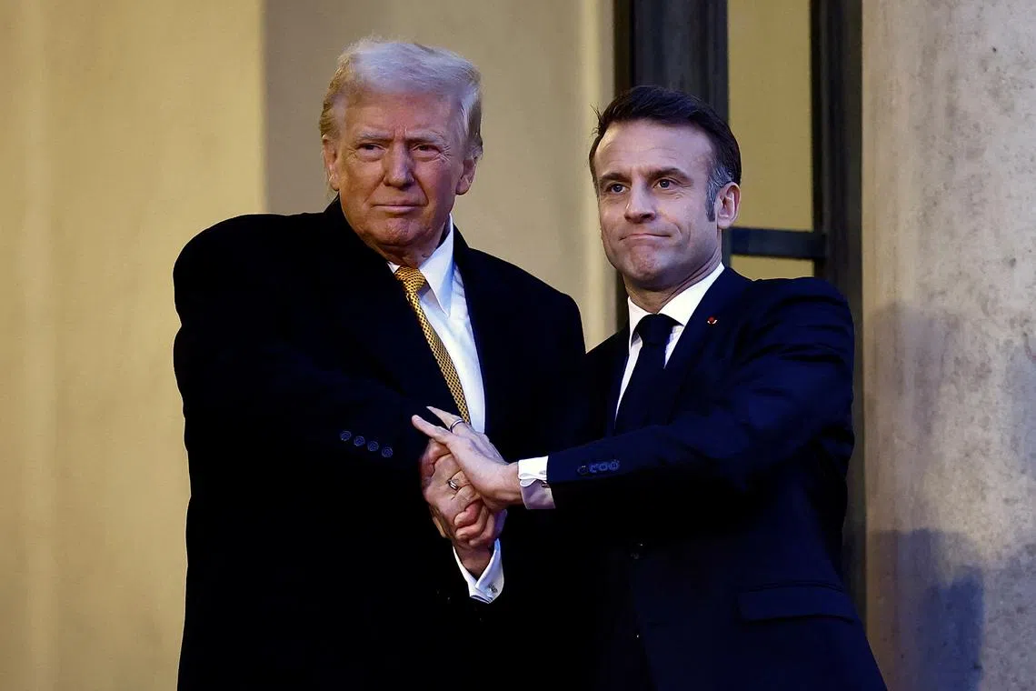 French President Emmanuel Macron shakes hands with U.S. President-elect Donald Trump as he arrives for a meeting at the Elysee Palace in Paris as part of ceremonies to mark the reopening of the Notre-Dame de Paris Cathedral, five-and-a-half years after a fire ravaged the Gothic masterpiece, in Paris, France, December 7, 2024. REUTERS/Sarah Meyssonnier