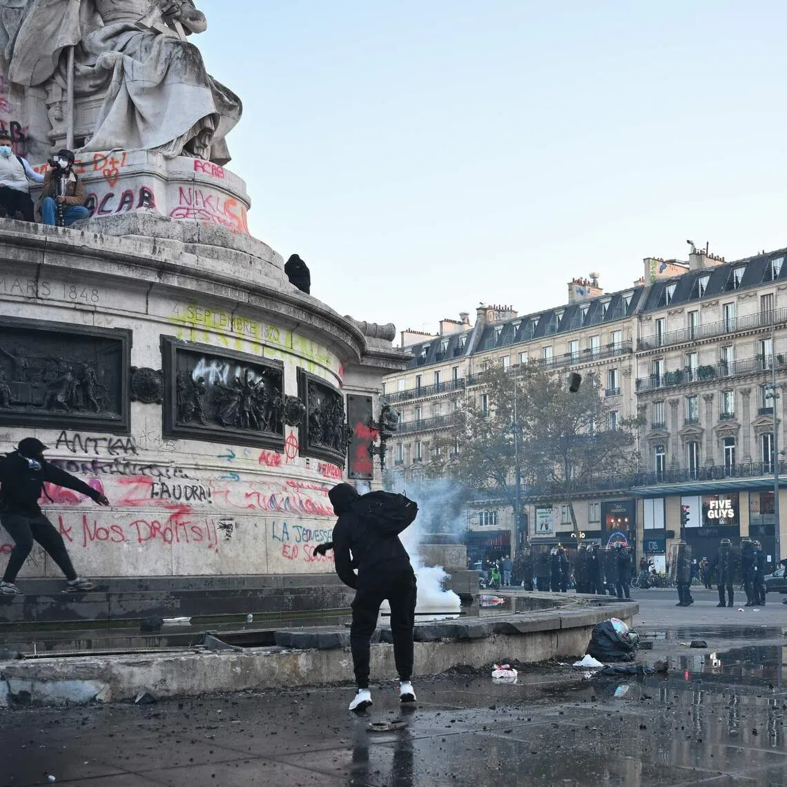 Protesters break up the fountain at the base of the Statue de La Republique to get stones as clashes erupted at Place de la Republique in Paris, on Oct 18.