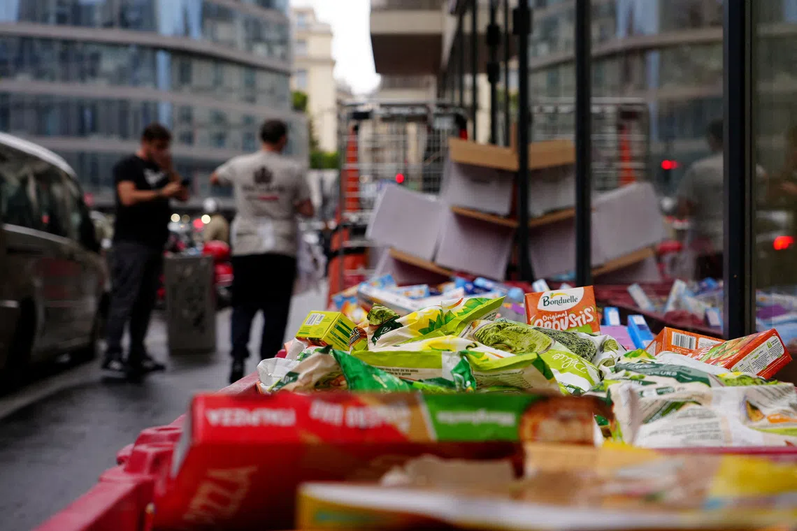 Boxes of perished goods are discarded outside an Intermarche supermarket in Paris on Oct 13, the day after a cyberattack targeted refrigeration systems at French chains, causing food losses and fires at several stores.