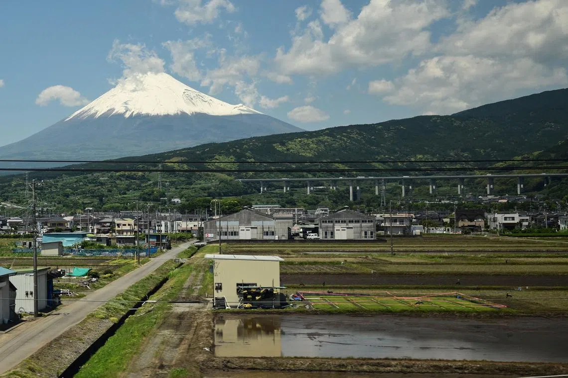Mountain Fuji is seen from a train travelling from Tokyo to Hiroshima, along the Tokaido Shinkansen, part of the nationwide high-speed railway network, in Shizuoka Prefecture on May 16.