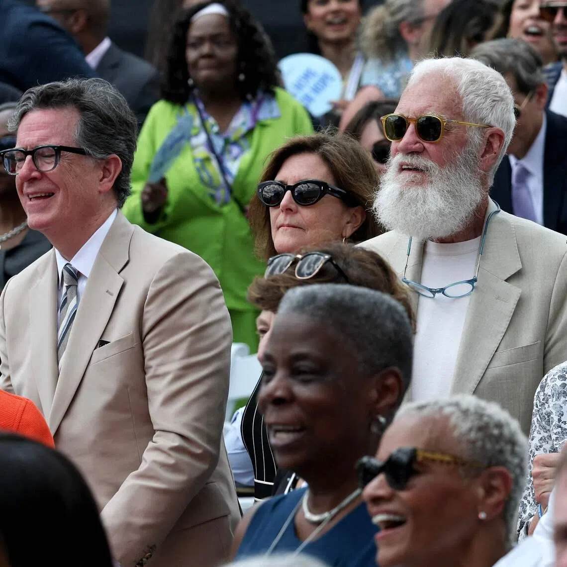 Stephen Colbert (left) and David Letterman dressed in similar khaki suits at the dedication ceremony for the opening of the Barack Obama Presidential Center in Chicago, Illinois, on June 18.