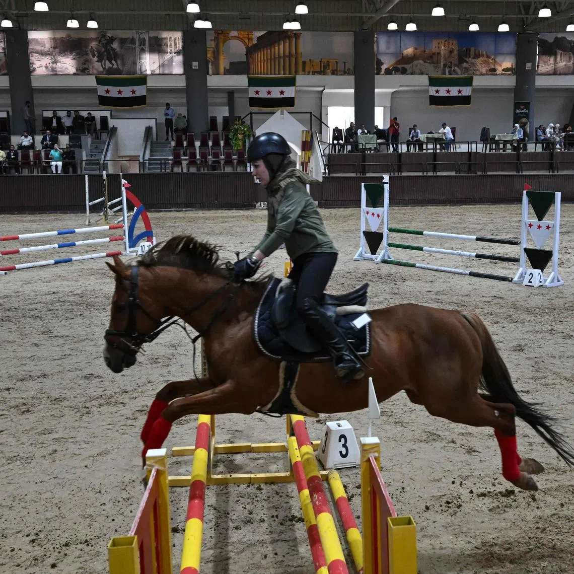 A horse rider competes during the fourth Al-Nasr Equestrian Show Jumping Championship at the Central Equestrian Club in Dimas, north-west of Damascus on May 9, 2025. For decades, equestrian sports were dominated by Syria's former ruling al-Assad family and their inner circle. But after the overthrow of Bashar al-Assad in a lightning Islamist-led offensive in December, new faces are competing amid growing interest in the sport. 