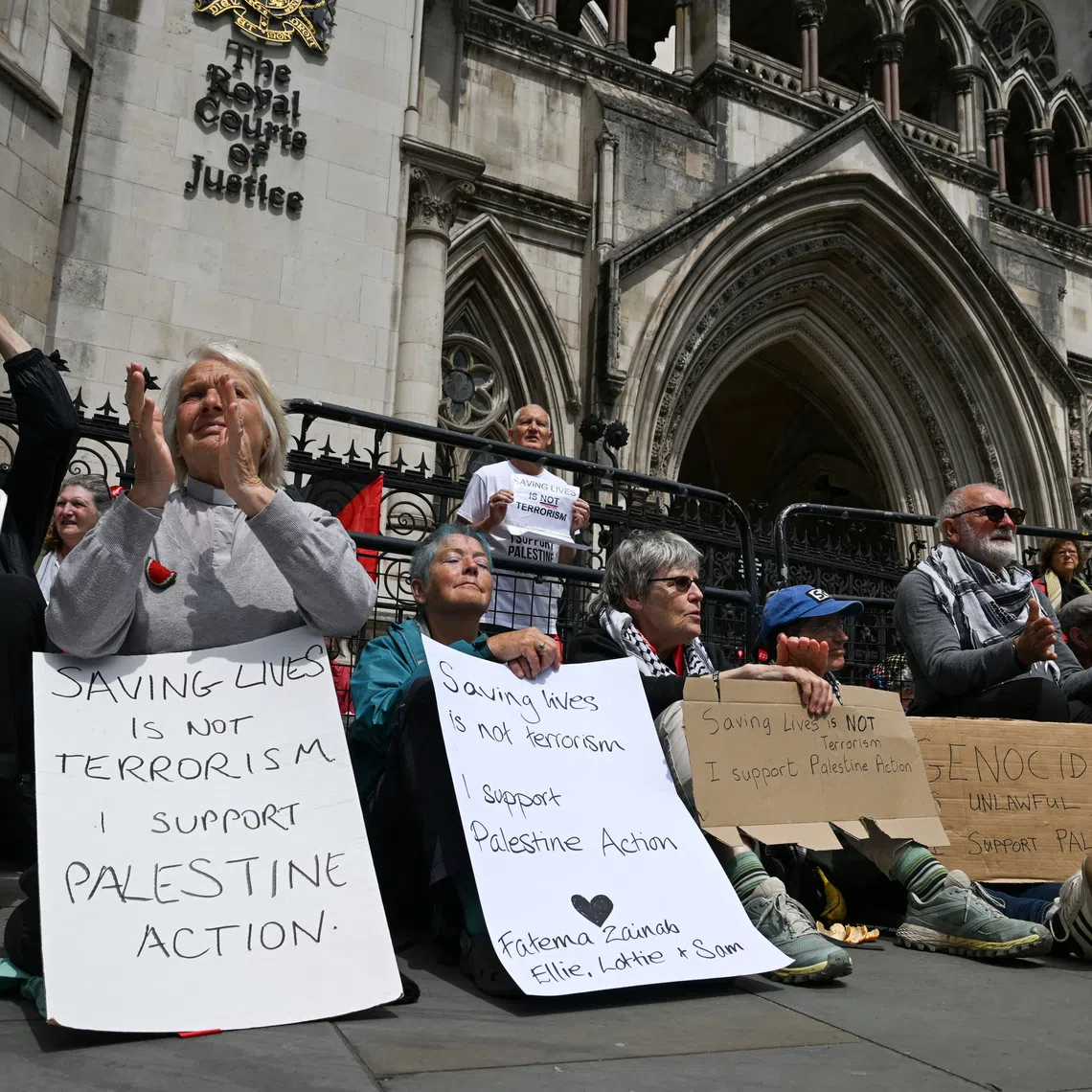FILE PHOTO: People attend a demonstration opposing the government's decision to ban Palestine Action as a terror organisation, following a Court of Appeal ruling on the lawfulness of proscribing the pro-Palestinian group under terrorism laws, outside the Royal Courts of Justice, in London, Britain, June 15, 2026. REUTERS/Chris J. Ratcliffe/File Photo