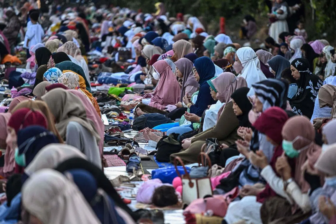 Muslims take part in a morning prayer celebrating the feast of Eid al-Adha in Surabaya on June 28.
