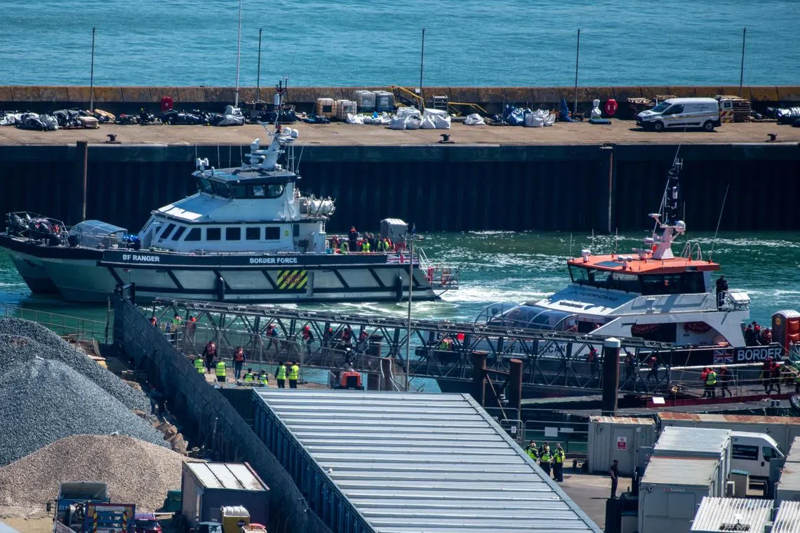 People believed to be migrants, disembark from a British Border Force vessel as they arrive at the Port of Dover in Dover, Britain, April, 29, 2024. REUTERS/Chris J. Ratcliffe