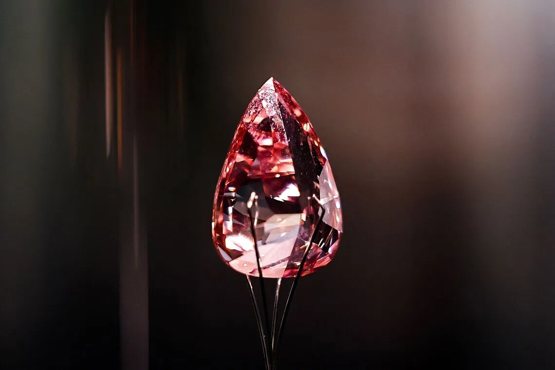 "The Desert Rose", a 31.86-carat vivid orangy-pink pear-shaped diamond, the largest of its kind ever graded, carrying an estimate of 5-7 million US dollars, on display as part of the auction series during the Sotheby's "Abu Dhabi Collectors Week" in Abu Dhabi, on Dec 2, 2025.