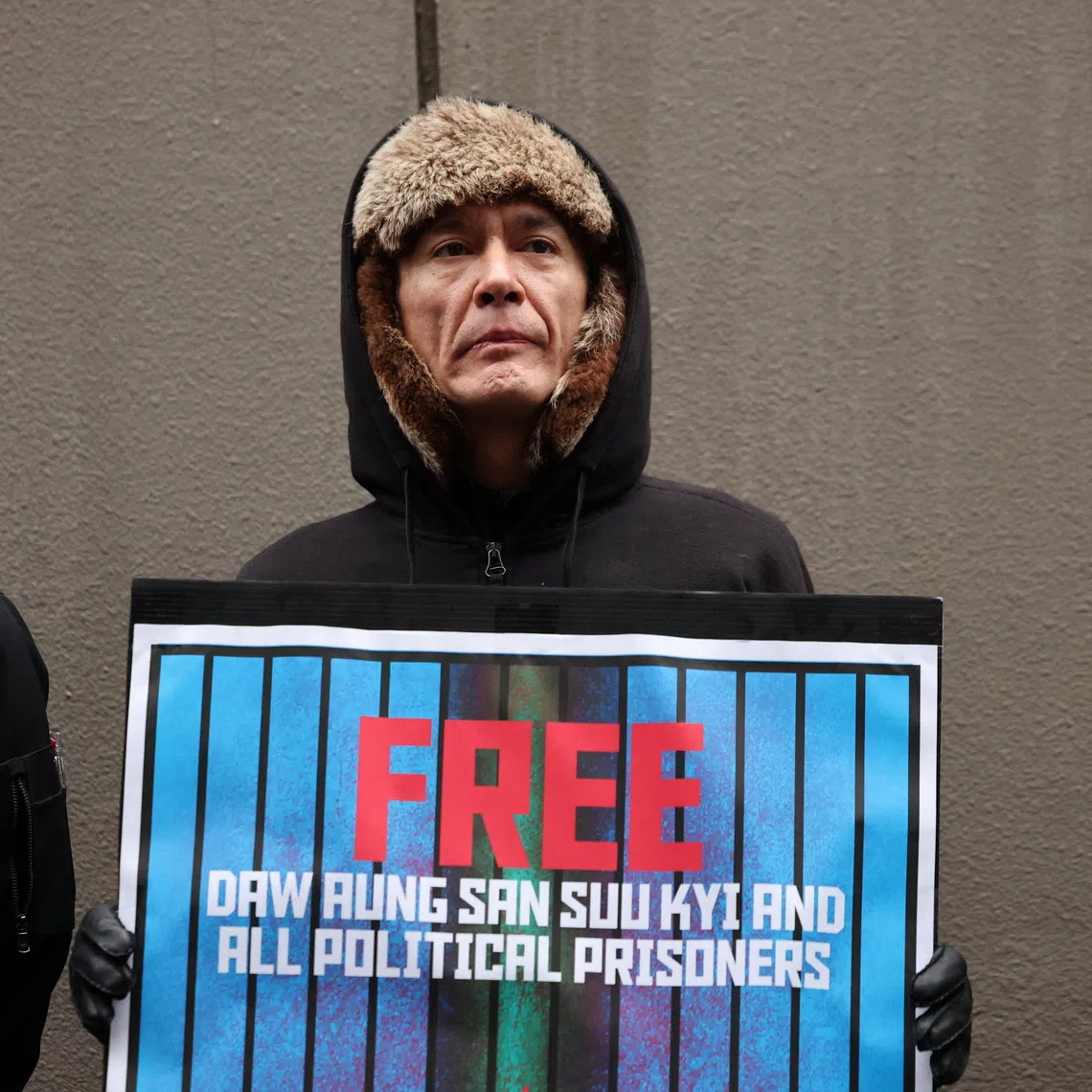 Kim Aris, the son of Aung San Suu Kyi, takes part in a protest rally organized by Myanmar people residing in Japan denouncing an upcoming election led by the military junta and demanding the immediate release of Myanmar's detained former leader Aung San Suu Kyi and all political prisoners, outside Myanmar's embassy in Tokyo, Japan, December 14, 2025. REUTERS/Issei Kato